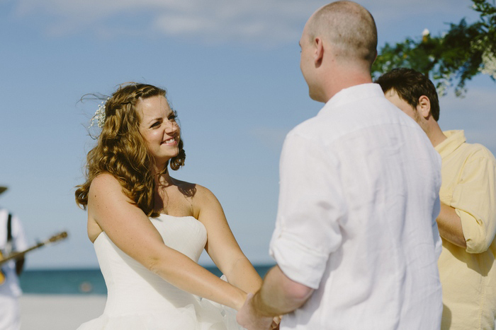 bride and groom exchanging vows on the beach