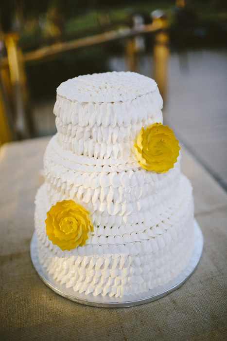 white ruffle wedding cake with yellow flowers