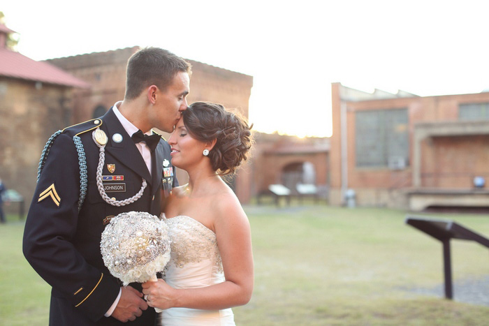 groom kissing bride's forehead