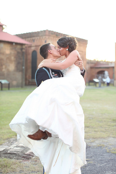 groom carrying bride