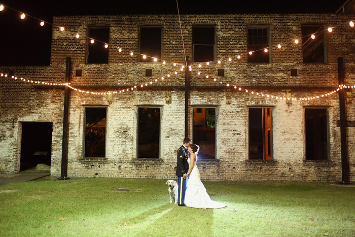 bride and groom under twinkle lights