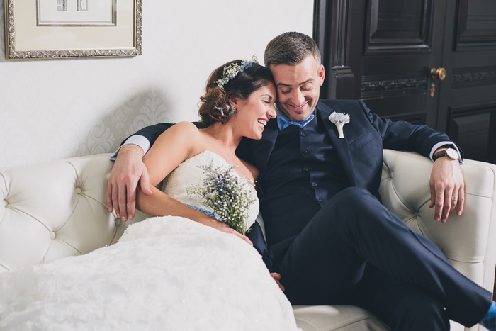 bride and groom cuddling on the couch