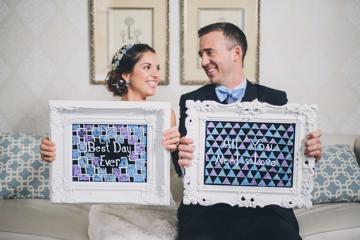 bride and groom with framed art