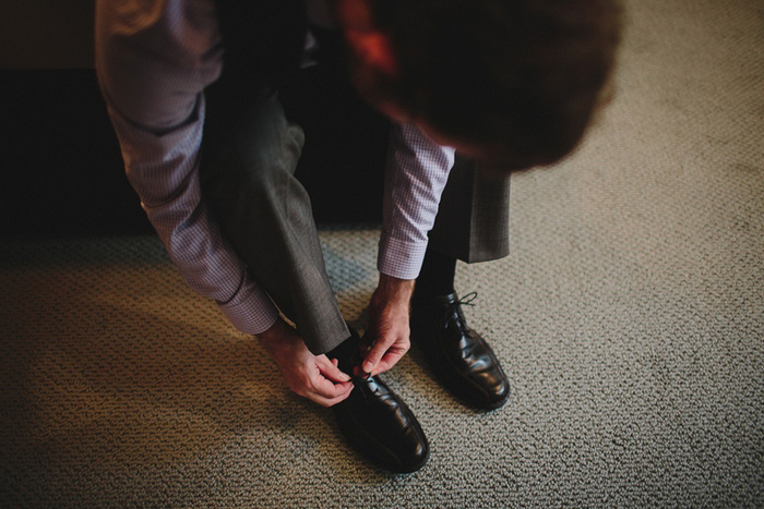 groom putting on his shoes