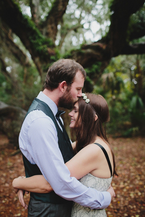 groom kissing bride's forehead