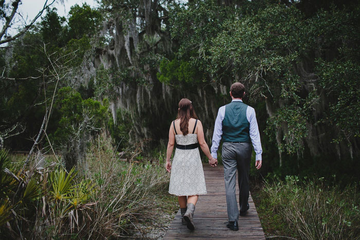 bride and groom walking on boardwalk