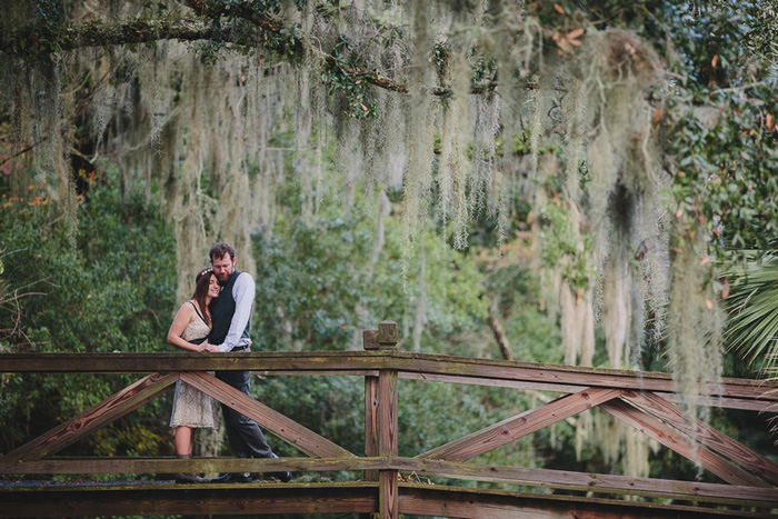 bride and groom on wooden bridge