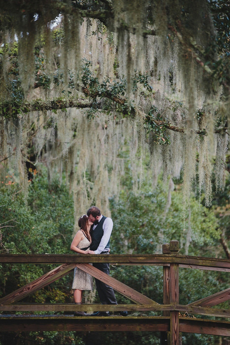 bride and groom on wooden bridge