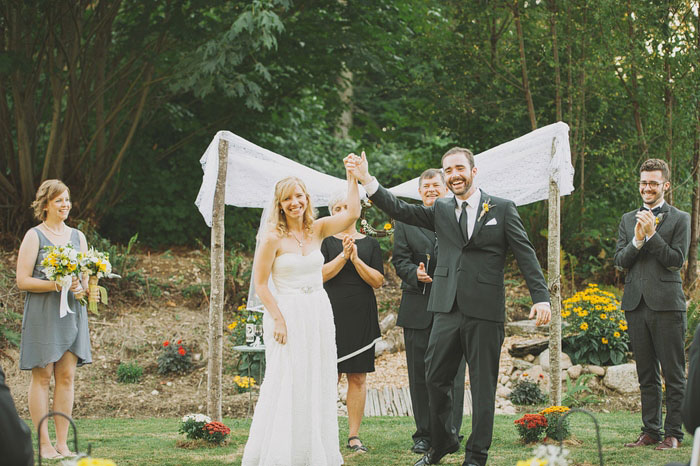 bride and groom victory pose