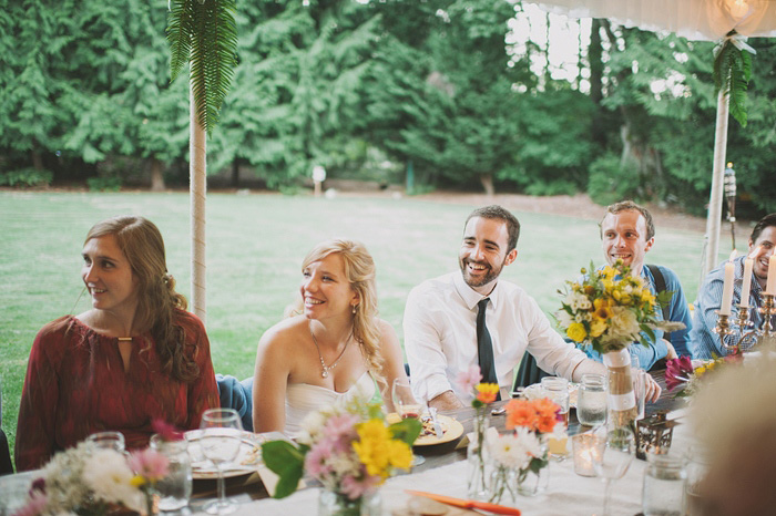 bride and groom listening to speeches