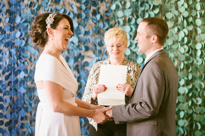 bride and groom laughing during ceremony