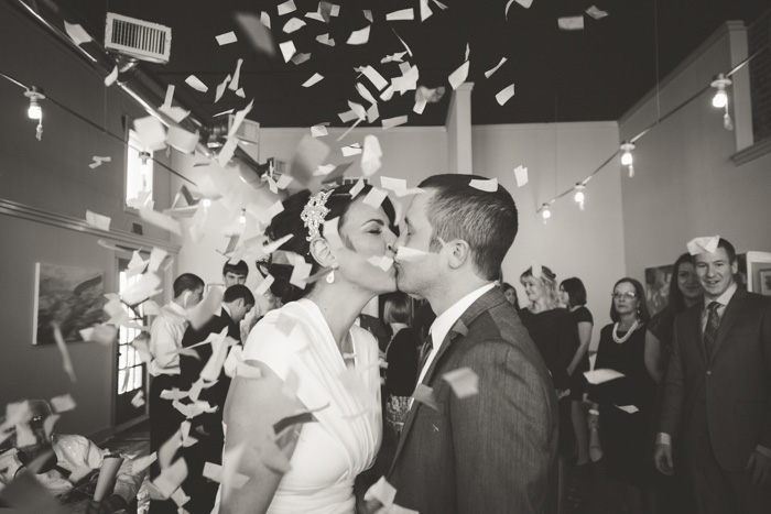 bride and groom kissing during confetti toss