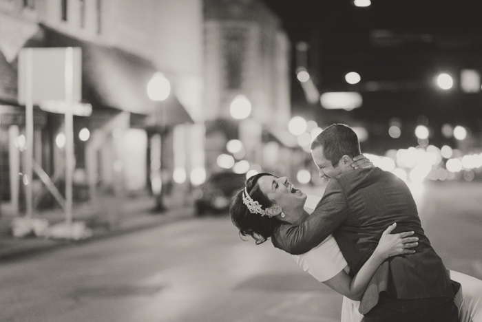 groom dipping bride in the street