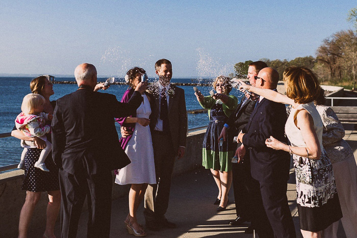 wedding guests throwing confetti on couple