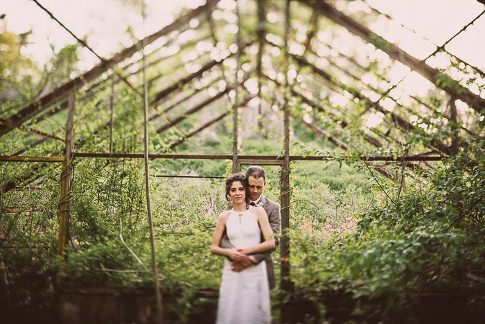 bride and groom in abandoned greenhouse