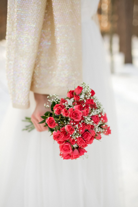 winter bride with red rose bouquet