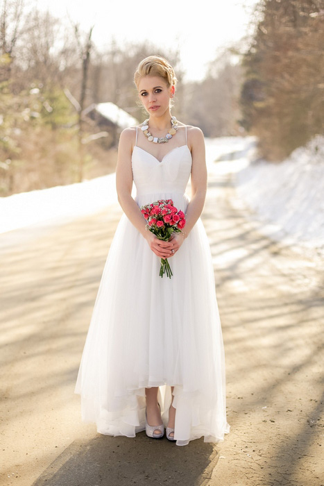 outdoor bridal portrait with red rose bouquet