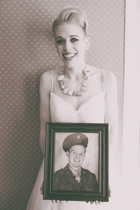 bride with vintage photograph of her grandfather