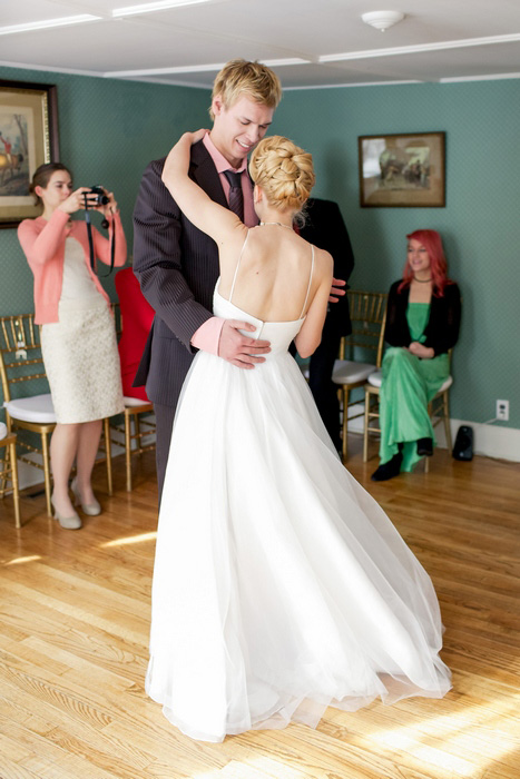 bride and groom dancing in living room