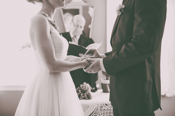 bride and groom holding hands during ceremony