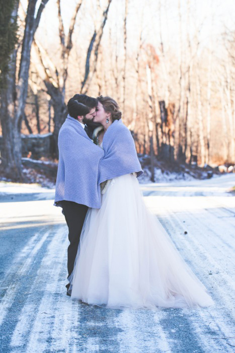 bride and groom wrapped in blanket