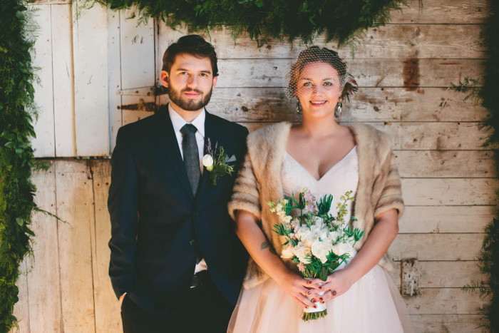 bride and groom on winter porch