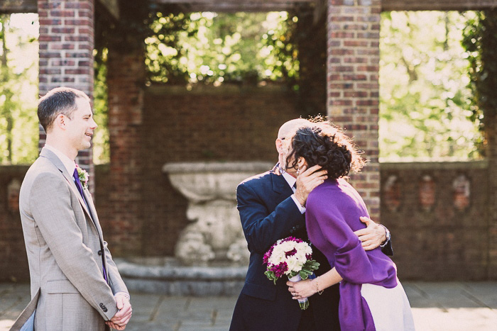 bride kissing father at wedding ceremony