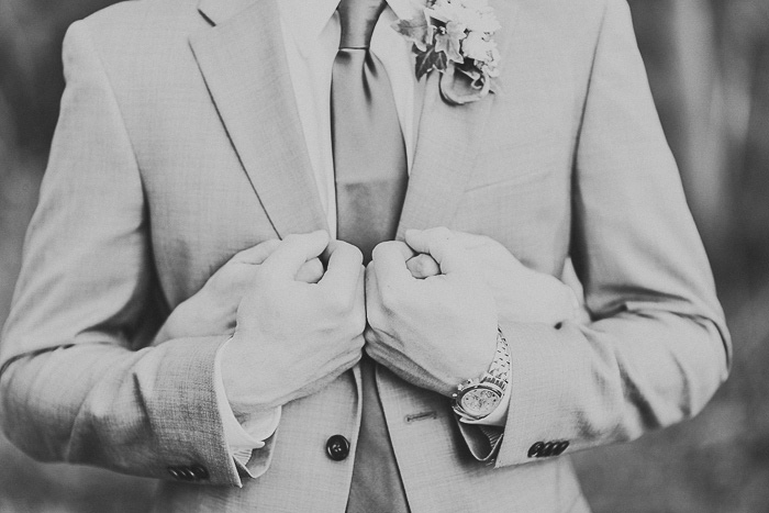 bride embracing groom from behind