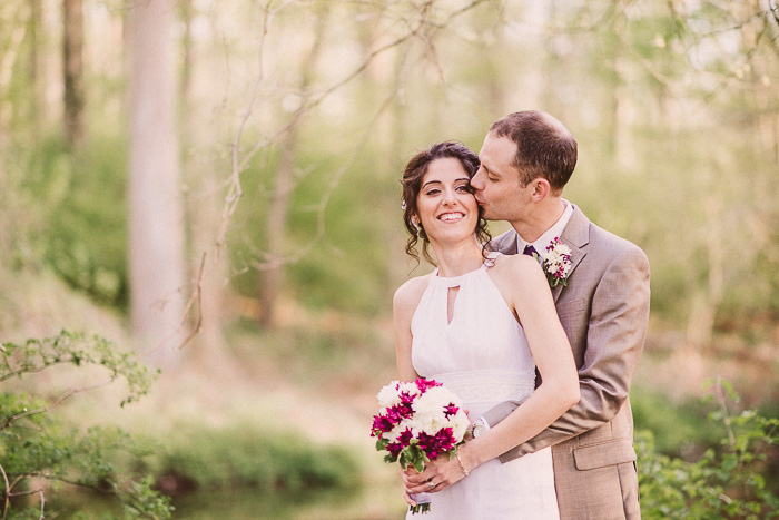 groom kissing bride on cheek