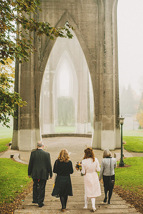 bride walking to ceremony in Cathedral park