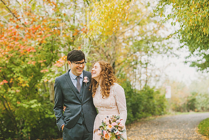 bride and groom walking in cathedral park