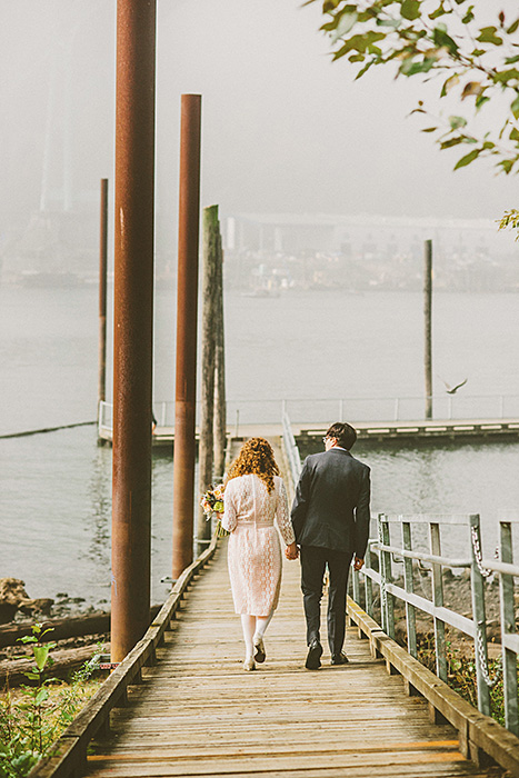 bride and groom walking down the pier