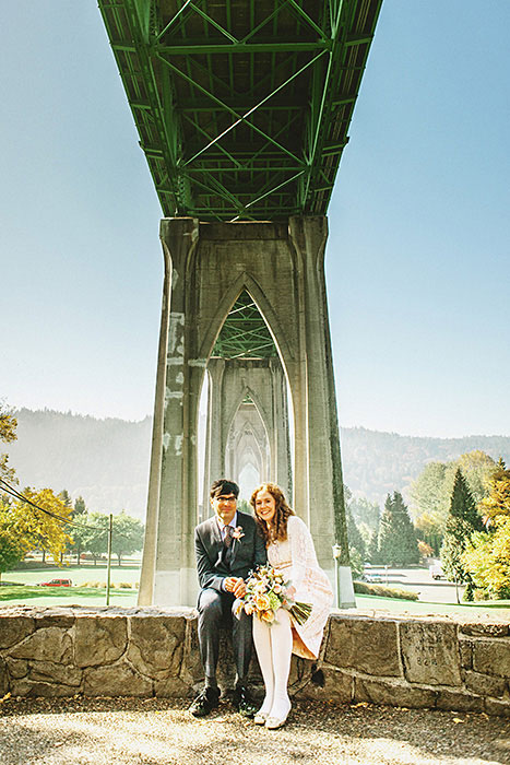 bride and groom under bridge