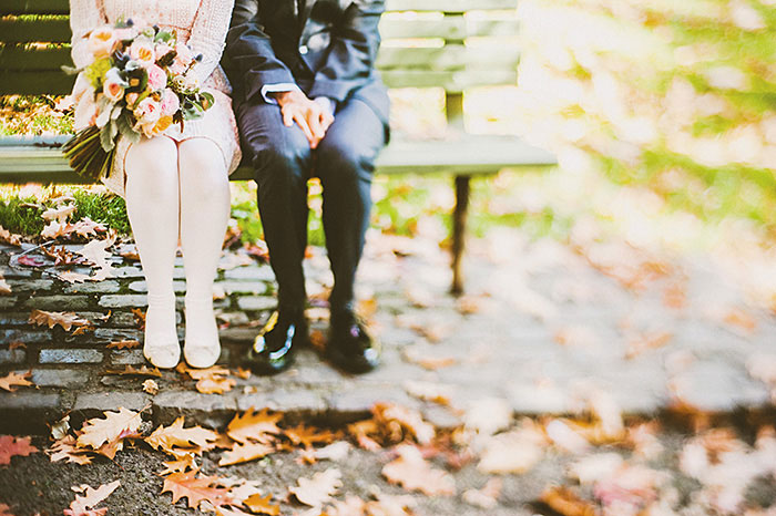 bride and groom on park bench