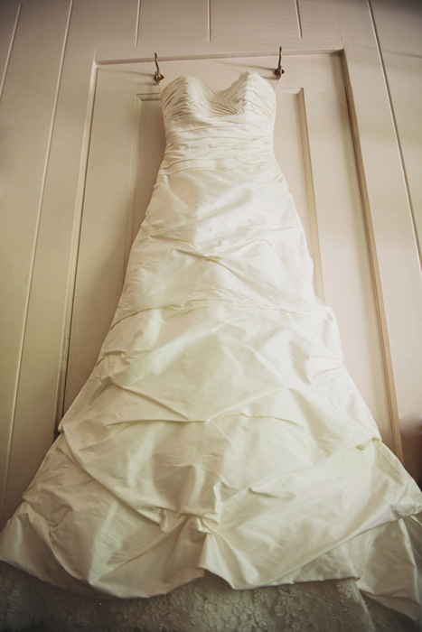 wedding dress hanging in room