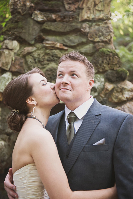 bride kissing groom on the cheek