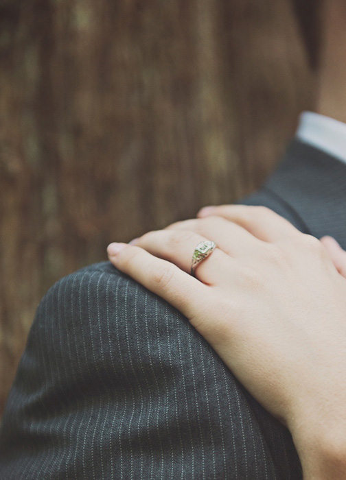 bride's hand on groom's shoulder