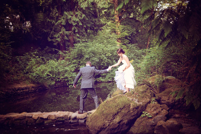 bride and groom trekking through the woods