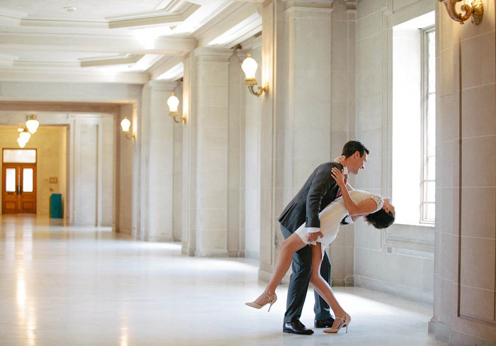 groom dipping his bride at city hall