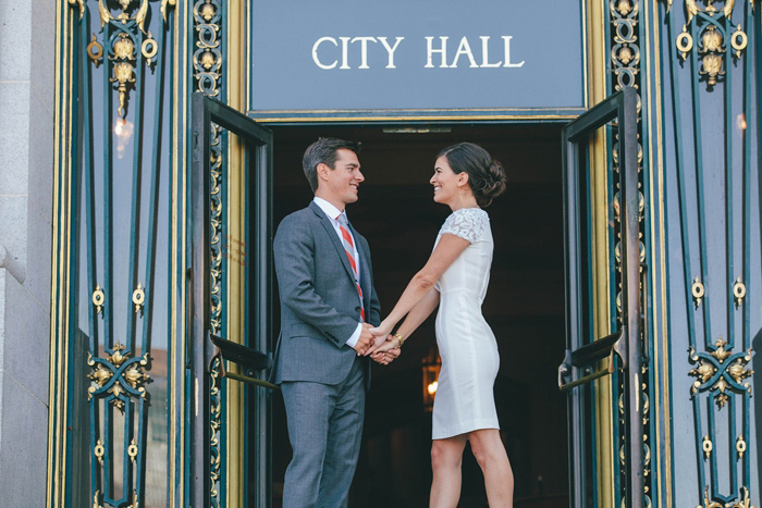 bride and groom in front of city hall