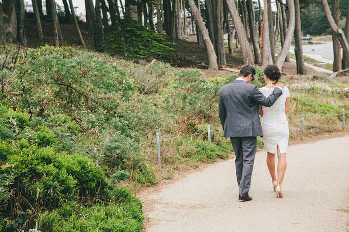 bride and groom walking in the park