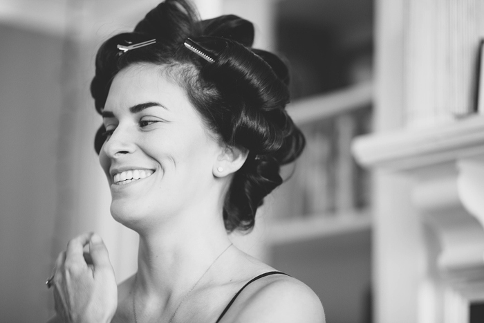 bride with her hair in rollers