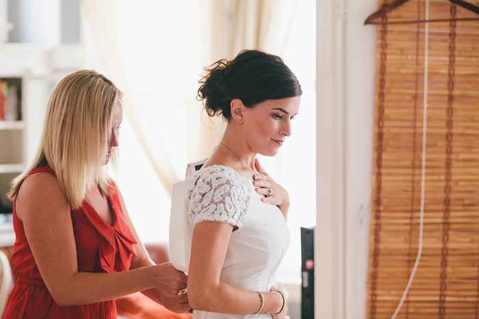 bride putting her dress on