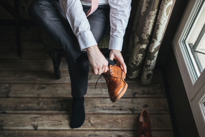 groom putting on his shoes