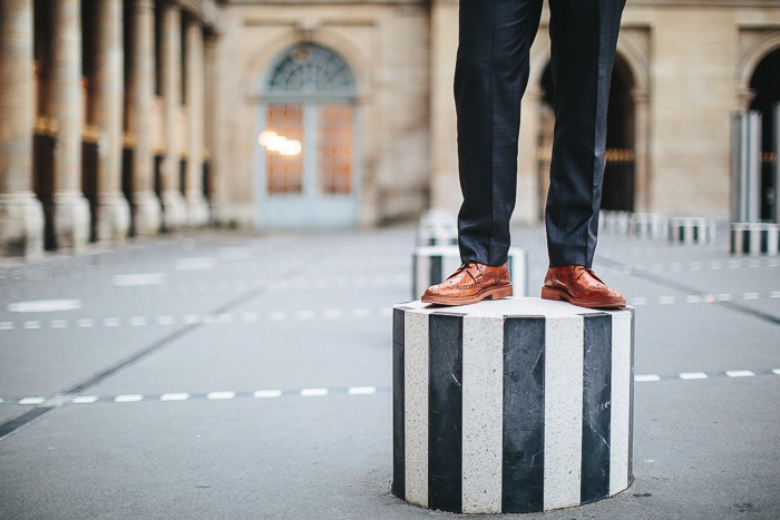 groom standing on striped concrete