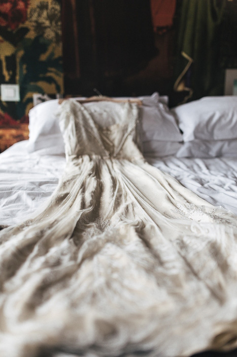 BHLDN wedding dress on bed