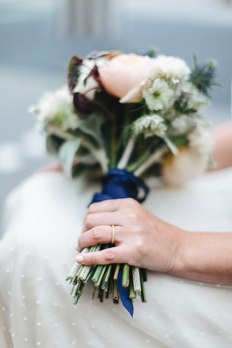 bride holding her bouquet on her lap