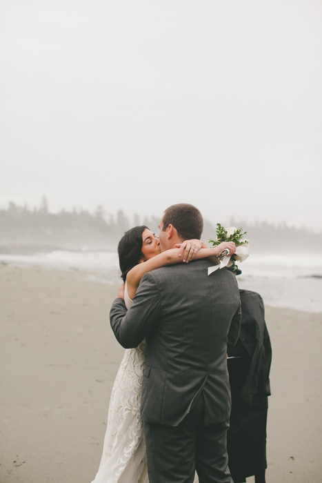 bride and groom first kiss on the beach
