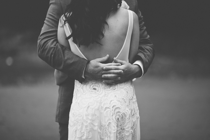 groom's hands around bride