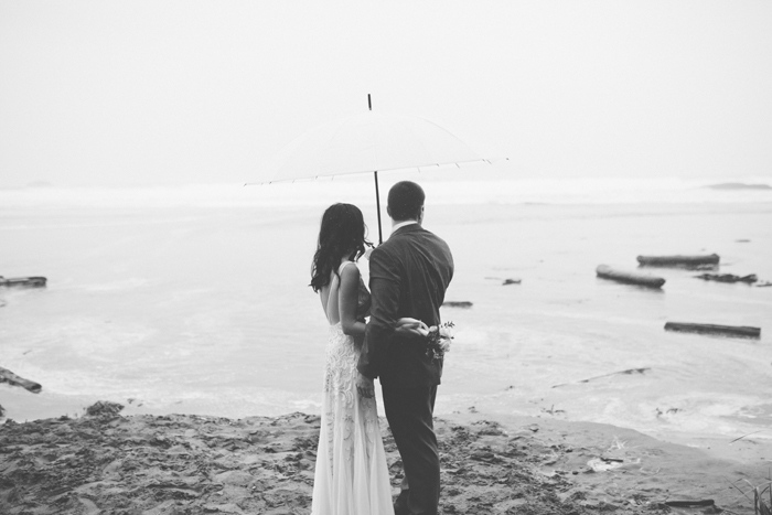 bride and groom looking out to the ocean